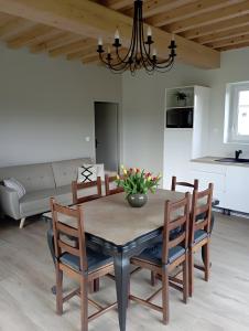 a kitchen and dining room with a table and chairs at Chambres D'hôtes Les Noisetiers in Saint-Martin-Lestra