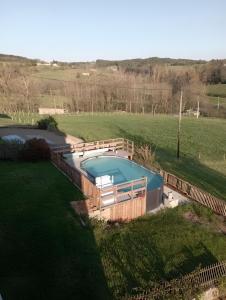 an overhead view of a swimming pool in a field at Chambres D'hôtes Les Noisetiers in Saint-Martin-Lestra