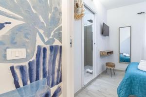 a bedroom with a mural of a tree on the wall at NURAS - Affittacamere L'Azzurra - Double bedrooms private bathroom and seaview solarium in Sorso
