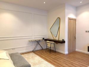 a bedroom with a bed and a desk with a mirror at Luxury 1 BR With Swimming Pool & 24 Hours Security In Lekki 1 in Lagos +16 photos