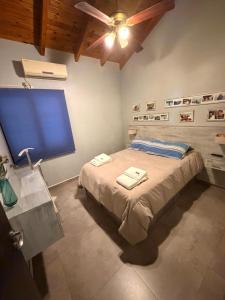 a bedroom with a bed with two towels on it at Mi hogar in Guaymallen