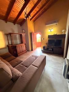 a living room with a couch and a television at Mi hogar in Guaymallen