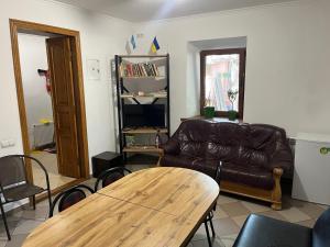 a living room with a couch and a table at FOX Hostel in Mykolaiv