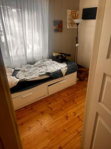 a small bed in a room with a window at Nordstrands Ro in Oslo