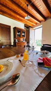 a table with wine glasses and fruit on a table at Ca Malfer in Costermano sul garda