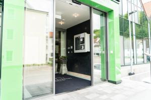 an entrance to a building with sliding glass doors at SEKRA Stadthotel in Heidenheim an der Brenz