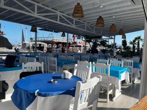 a restaurant with blue and white tables and chairs at AsiaHOTEL in Bodrum City