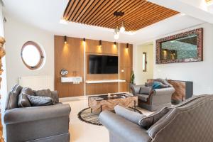a living room with two couches and a tv at The Infinities - Premium Villa Alexandros in Kos +61 photos