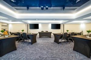 a conference room with tables and chairs and a podium at Hotel Royal William, an Ascend Collection Hotel in Quebec City