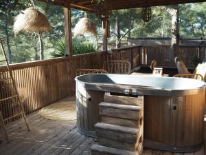 a hot tub on a deck with a table at Villa Occitana in Calvisson