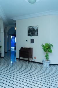 a room with a piano and a potted plant at Le Wallo - Residence Sebi in Sébikhoutane +11 photos