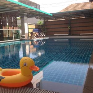 a yellow rubber duck sitting in a swimming pool at Baan Tanwa - MRT Ratchadapisek Exit 1 or 2 in Bangkok
