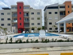 a pool in front of some apartment buildings at Apartment With Swimming Pool close to Beach in La Romana