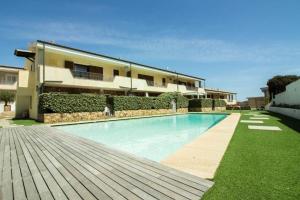 a swimming pool in front of a house at GuestHost - Gabbiano Lovely Flat with Veranda in Palau