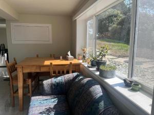 a dining room with a table and a window at ocean view two bedroom suite in Oak Bay