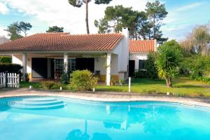 a house with a swimming pool in front of a house at Verdizela Pool & Barbecue Villa in Corroios