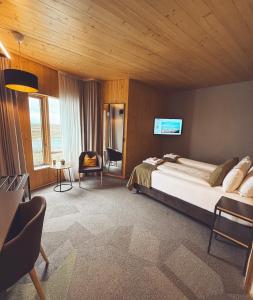 a bedroom with a bed and a tv on the wall at Landhotel in Hella