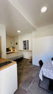 a room with two beds and a table and a kitchen at City Room Filip without window in Poreč