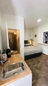 a kitchen with a sink and a bed in a room at City Room Filip without window in Poreč