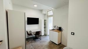 a room with a table and a kitchen with a desk at City Room Filip without window in Poreč