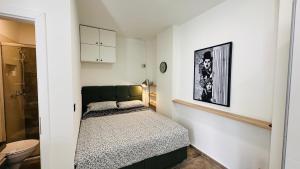 a small bedroom with a bed and a bathroom at City Room Filip without window in Poreč