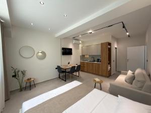 a living room with a bed and a kitchen at Megan's Villa in Durrës