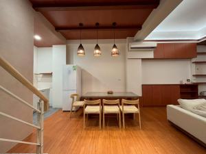 a kitchen and dining room with a table and chairs at White in Gukeng