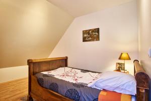 a bedroom with a bed and a lamp on a floor at La Matheysiene in La Motte-dʼAveillans
