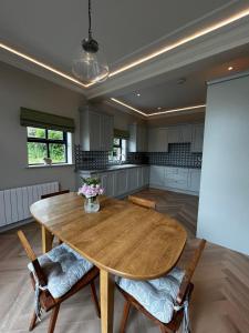 a large kitchen with a wooden table and chairs at Teach na Radharc in Raheen
