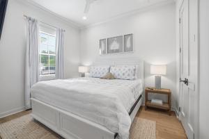 a white bedroom with a large bed and a window at Spacious 3BR - Pool - Beach Nearby in Pass Christian +31 photos