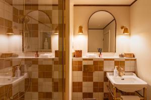 a bathroom with a shower and a sink and a mirror at The General Tarleton in Knaresborough