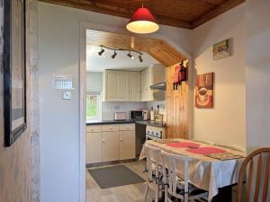 a kitchen and dining room with a table and chairs at Cottage 507 - Renvyle in Renvyle