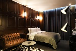 a hotel room with a bed and a couch at Cheonan La Tree Hotel in Cheonan