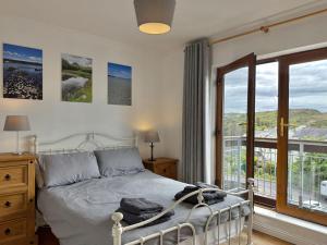 a bedroom with a bed and a large window at Apartment 514 - Clifden in Clifden