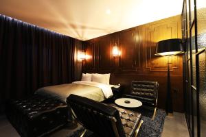 a hotel room with a bed and a table and chairs at Cheonan La Tree Hotel in Cheonan +18 photos