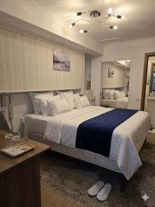 a hotel room with a large bed and a desk at Studio MD in Chişinău