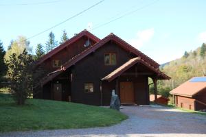 a black house with a red roof at Chalet Heidi in Ventron