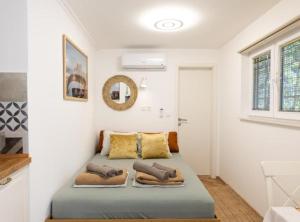 a bedroom with a bed with pillows on it at Marghareta Nest 2 - TOP Location in Dubrovnik +28 photos
