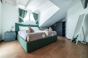 a bedroom with a green bed with teddy bears on it at CHALET LAURA apricacasevacanze in Aprica