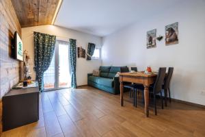 a living room with a table and a couch at CHALET LAURA apricacasevacanze in Aprica