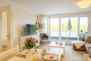 a living room with a couch and a table at Mein-Zingst-Urlaub in Zingst +7 photos
