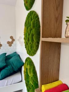 a room with green plants on the wall at BioKompas SPA Apartment in Wrocław