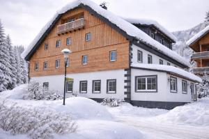 a large building with snow on the ground at Katschbergstubn in Sankt Michael im Lungau
