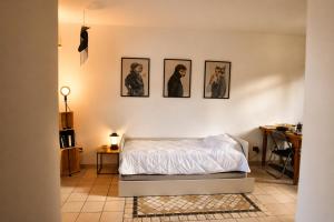 a bedroom with four pictures on the wall at The Other Side in Lainate