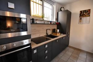 a kitchen with a sink and a stove at The Other Side in Lainate