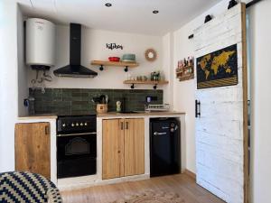 a kitchen with wooden cabinets and a black stove at Puerto de Jávea in Jávea