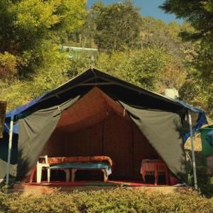 a tent with a bench inside of it at Forest Stay - by TripInterval in Nainital