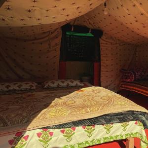 a bedroom with a bed in a tent at Forest Stay - by TripInterval in Nainital