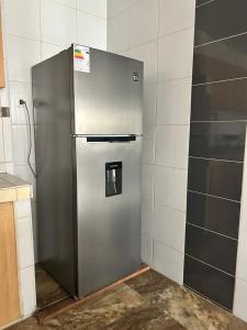 a stainless steel refrigerator in a kitchen at Casa Totora in Huanchaco