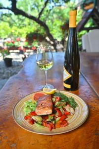 a plate of food and a glass of wine on a table at Vila Prezident in Sremski Karlovci +27 photos